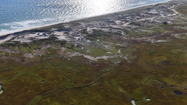 Morning sunlight shines on an extensive salt marsh in Orleans, Cape Cod, MA. Salt marshes are an incredibly important coastal habitat used by many species of fish, birds, and shellfish.