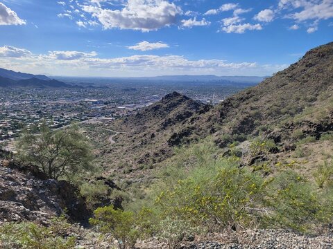 High-angle view of the Phoenix cityscape from the rugged desert slopes of the Phoenix Mountains Preserve, Arizona