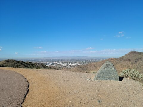 Scenic overlook from North Mountain Park in Phoenix Arizona with a large rock monument and Glendale valley view