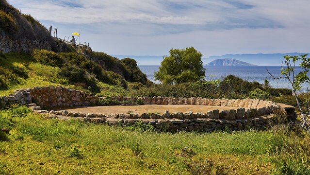 Stone circle, old threshing floor, round building and ruins directly on the coast with a view of the sea and an island, Livadi Kalogiron, Patmos, Dodecanese, Greek Islands, Greece
