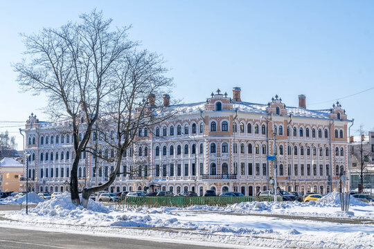 Vologda historic Hotel Golden Anchor with ornate eclectic facade across snowdrifts on a sunny winter day in Russia.
