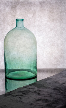Large empty glass jar on a gray background