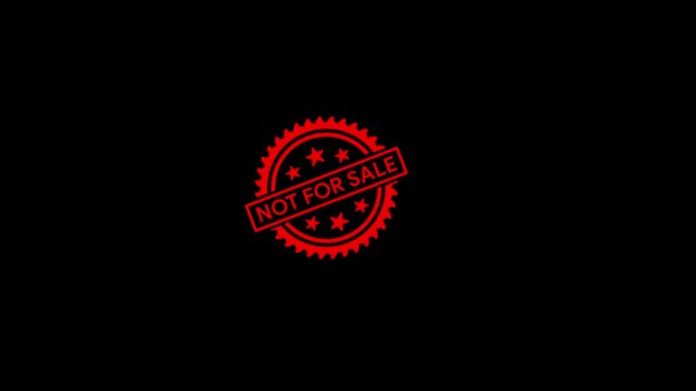 hand holding a red circular rubber stamp displaying not for sale text, representing product restrictions, sales limitations, and commercial notices.