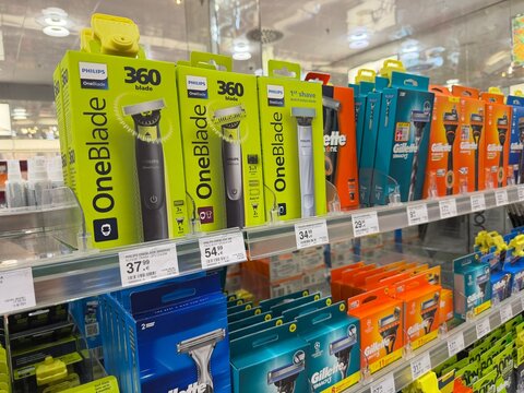 Mallorca, spain, october 10, 2026, philips oneblade and gillette razors lining a retail shelf, showcasing shaving and grooming products in palma, spain