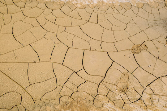 Dried Cracked Earth Soil Ground Texture Baked in Sun with Footprints