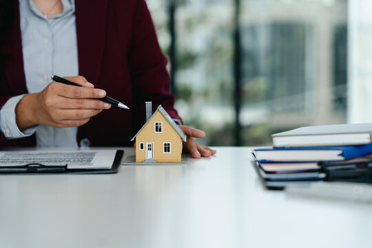 real estate agent with model house selling concept