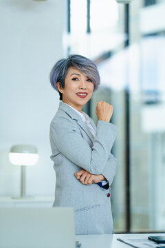 portrait of Asian senior businesswoman with laptop in office