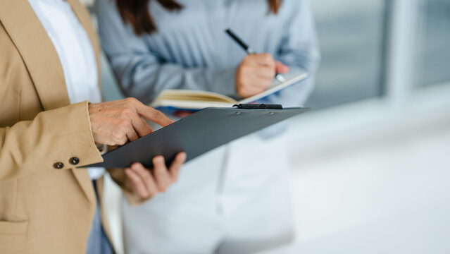Asian senior businesswoman working with colleague working together