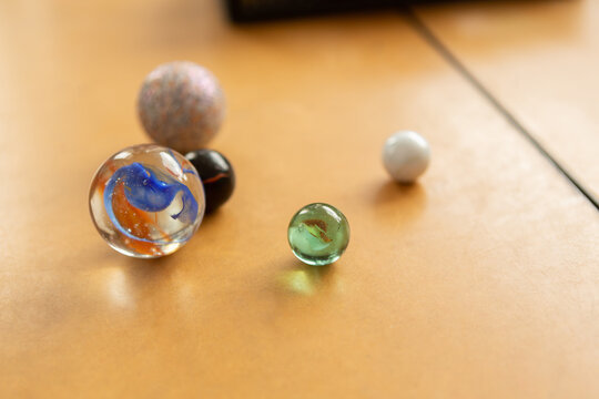 Close-up of marbles on desk in classroom