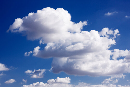 Fluffy white clouds in a clear blue sky