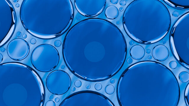Close-up abstract of blue liquid bubbles forming circular patterns