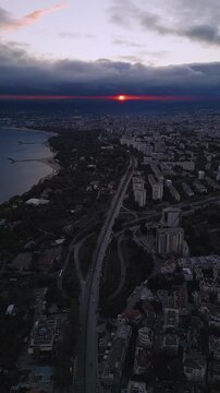 Aerial view of Varna city and Black Sea coast at dramatic red sunset, Bulgaria
