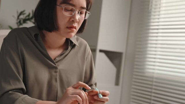 Accounting and finance work, female accountant reading and checking financial documents, reviewing paperwork, tapping paper thoughtfully and using calculator at office desk for audit, bookkeeping 