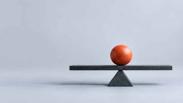 Red sphere perfectly balanced on dark stone seesaw structure representing equality stability and precarious risk management