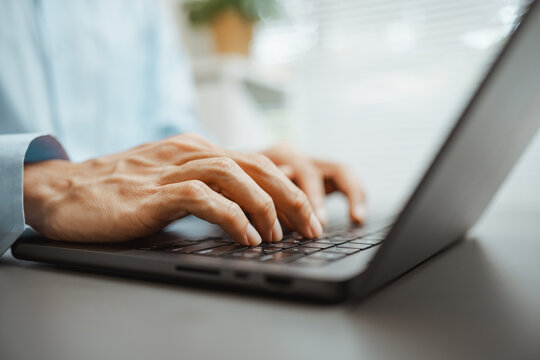 Using freelance laptop with hand typing is illustrated in a close view of hands at a keyboard on a desk, connecting freelance work with laptop productivity and digital business communication.