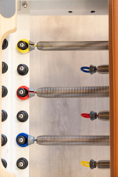 Pilates reformer resistance springs and color-coded tension settings
