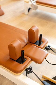 Pilates reformer with leather padded carriage and adjustable support blocks