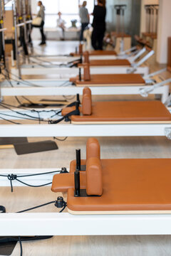 Pilates reformer machines in a bright fitness studio