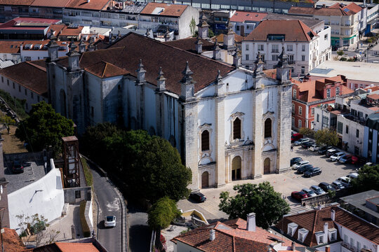 Elevated view of Leiria Cathedral in the historic center of Leiria Portugal surrounded by red tiled roofs and city buildings