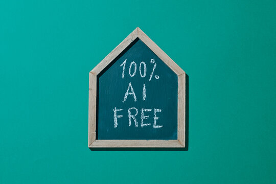 a house-shaped chalkboard with text 100% AI FREE