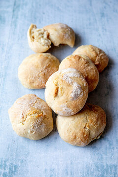 Spelt bread rolls on a textured surface