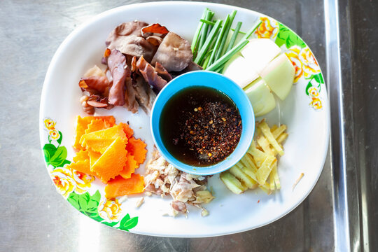 Thai food ingredients with spicy sauce on plate