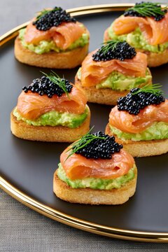 Smoked salmon and caviar canap&eacute;s on avocado toast