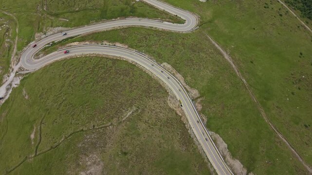 Sinuous Mountain Highway Across Alpine Meadow