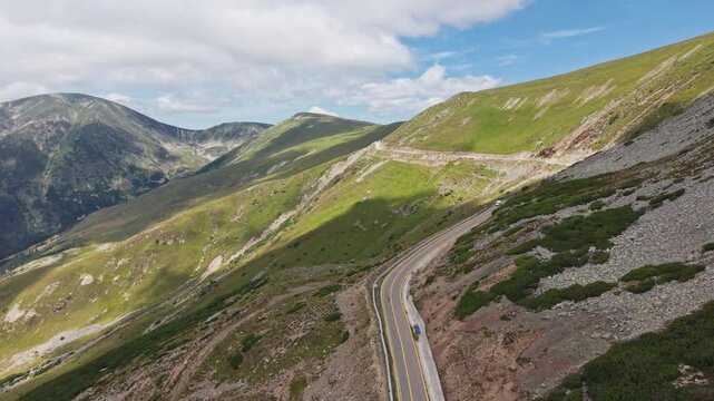 Mountain Highway Cut Through Rugged Green Slope