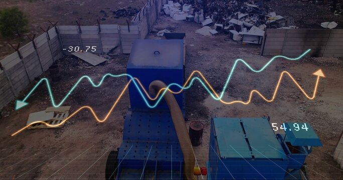 Blue machinery sitting near concrete barriers beneath line graphs showing rising trends with arrows