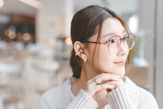 Closeup beautiful young adult business asian woman wear eyeglasses looking out window confidence eye vision background with copy space
