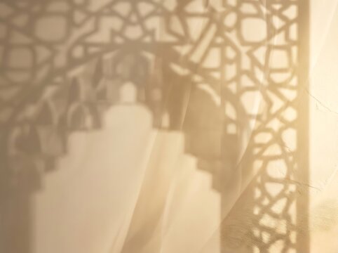 Soft shadows of islamic geometric archways cast on textured wall.