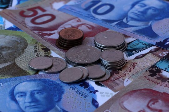 Canadian dollar money notes and coins on table. Canada cash bills of CAD currency close up