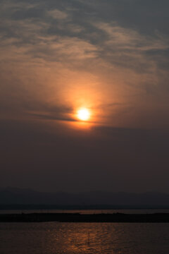Golden Sunset Over a Calm Body of Water