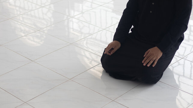 Muslim Man Praying on Tiled Floor in Mosque