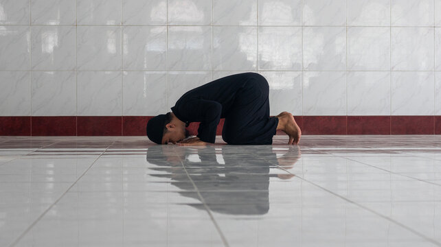 Muslim Man Performing Prostration Prayer in Mosque