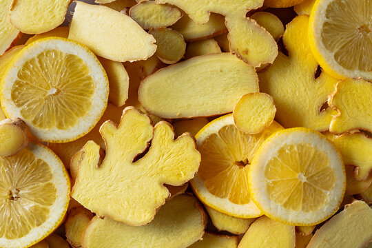 Close-up of fresh ginger and lemon slices.