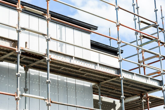 Scaffolding around second story of building under construction