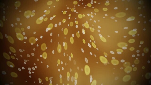 Golden glowing particles drifting across an abstract brown background