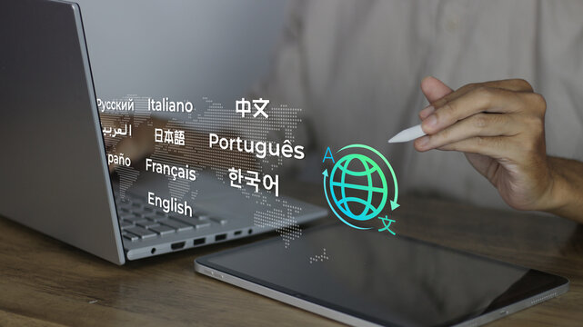Multilingual language translation technology concept. Businessman using laptop with icons various languages, global translation, multilingual communication, international connections, AI translator