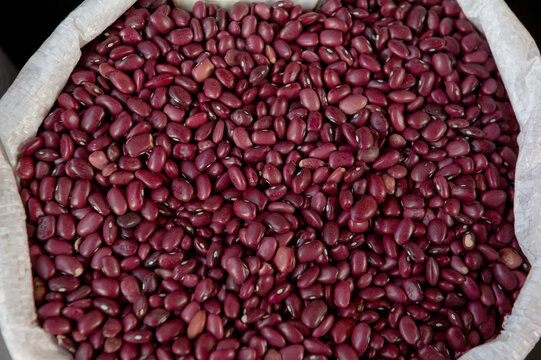 Red bean sack market background. Organic raw legume pile texture