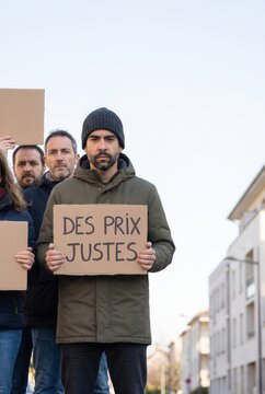Protester holding a French sign calling for fair prices