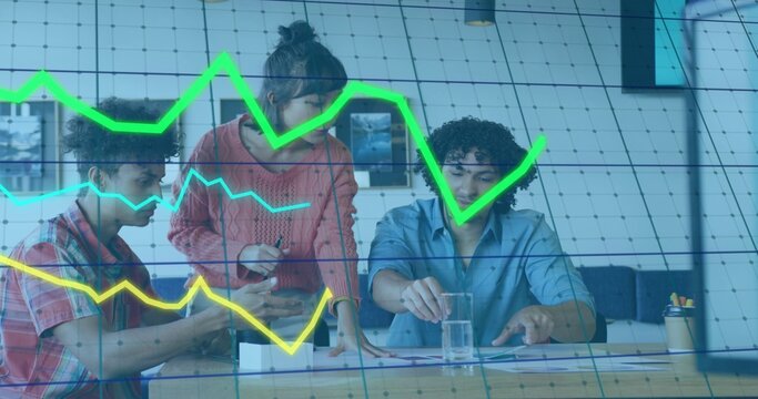 Three colleagues reviewing documents and tablet while green charts overlaying table, copy space