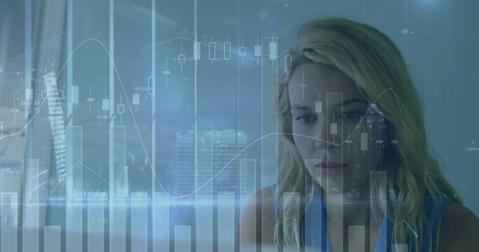 Blonde woman reviewing stock charts overlaying glass window with blurred city skyline behind