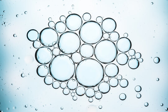 Blue transparent oil bubbles forming an abstract liquid texture