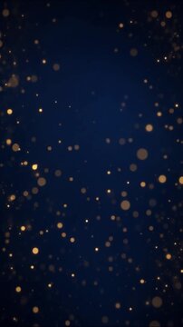 Golden particles floating upwards against a dark blue background creating a festive sparkling atmospheric ambiance