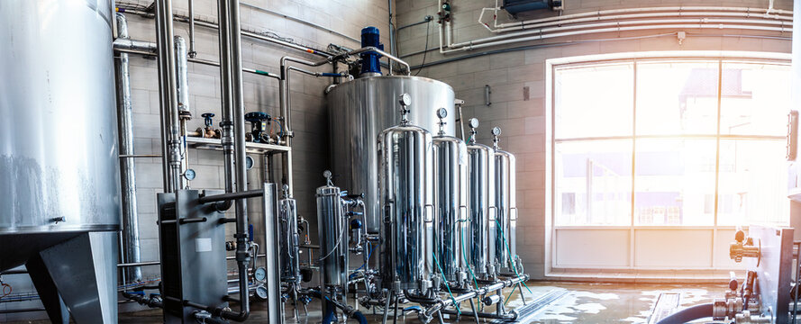 Industrial Liquid Filtration and Beverage Processing System with Stainless Steel Pressure Vessels, Gauges and Pipelines Inside Modern Factory