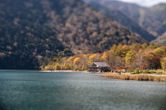Dreamy selective focus lodge on an autumn mountain lake shore