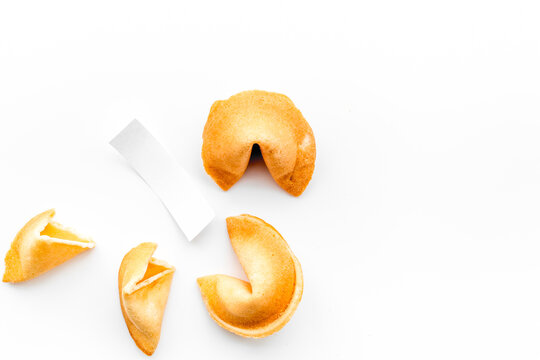 Chinese fortune cookie with prediction on white background top view space for text