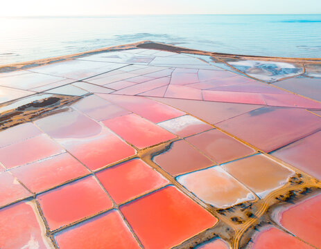 Colorful Coastal Salt Evaporation Ponds with Pink and Red Water in Geometric Patterns